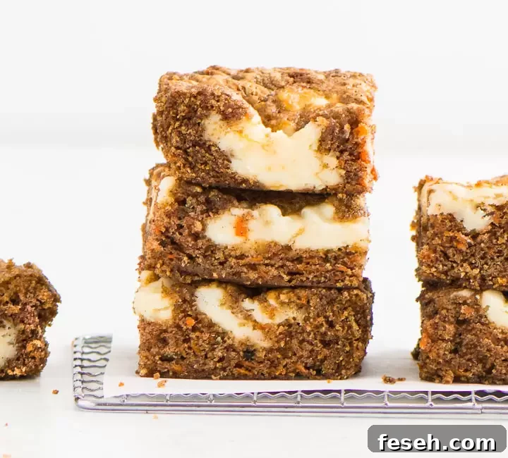 Chewy Carrot Cake Bars with Cream Cheese Frosting 2 stack of carrot cake bars on a wire rack