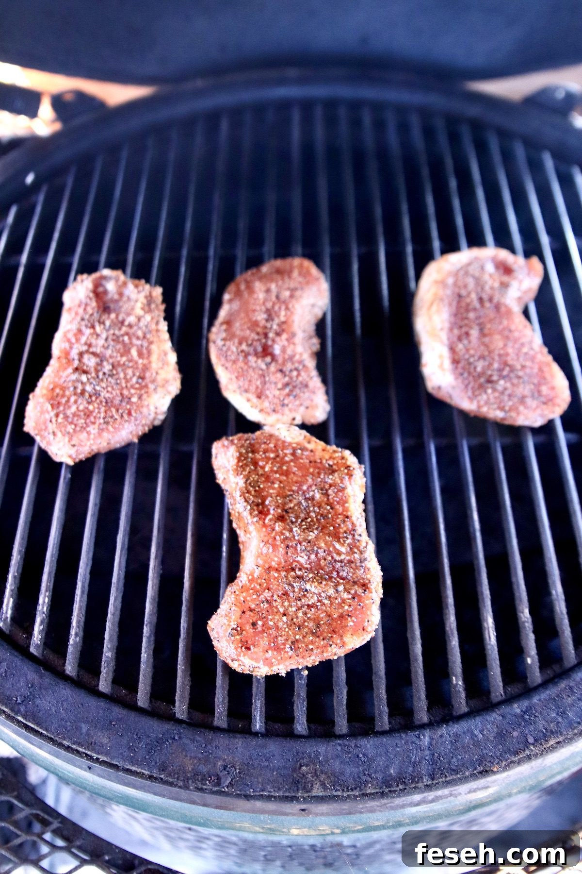 4 pork chops on a grill