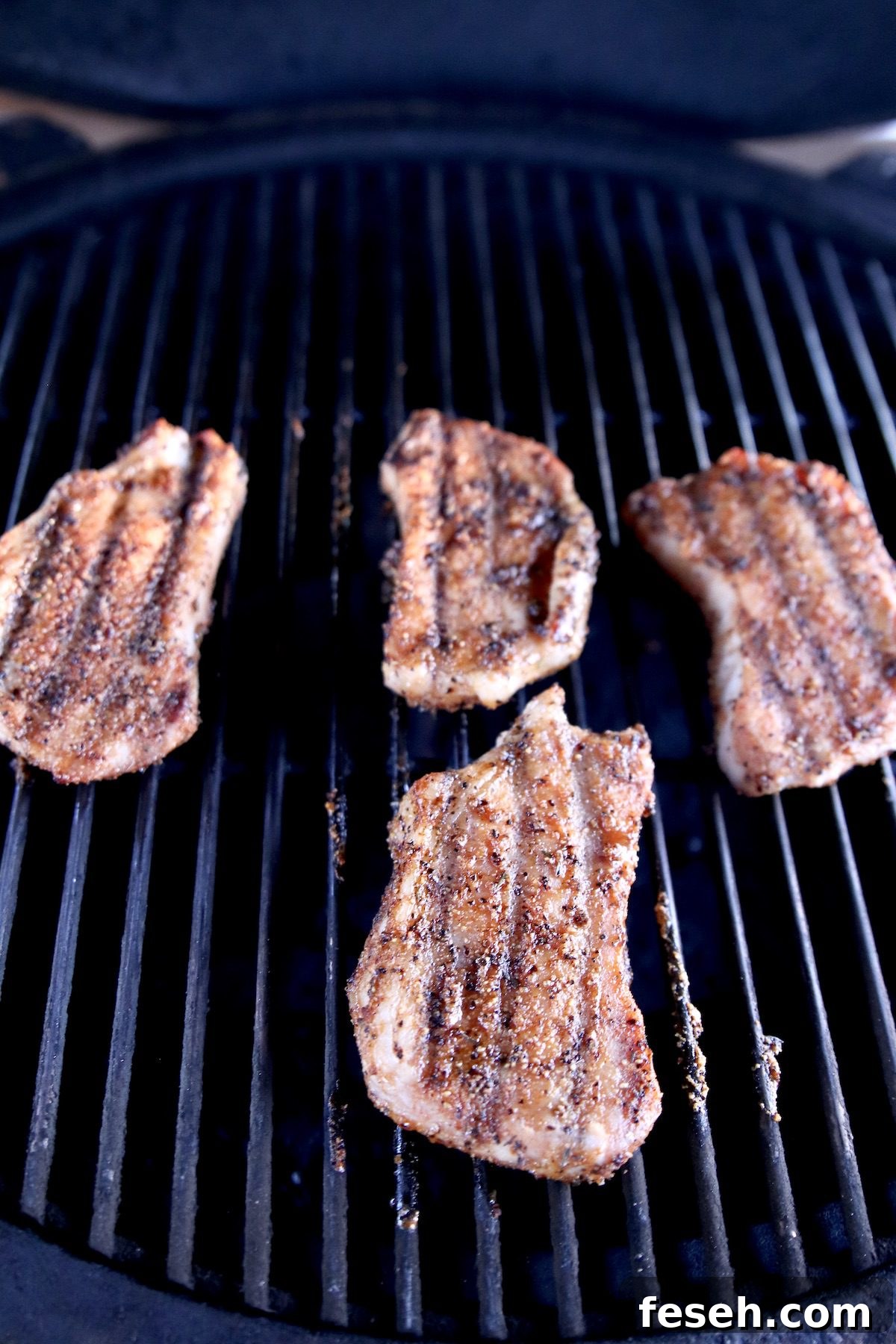 4 pork chops on grill - with grill marks