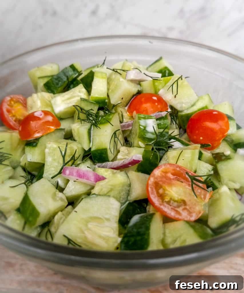 a bowl of German Cucumber tomato salad with mayo.