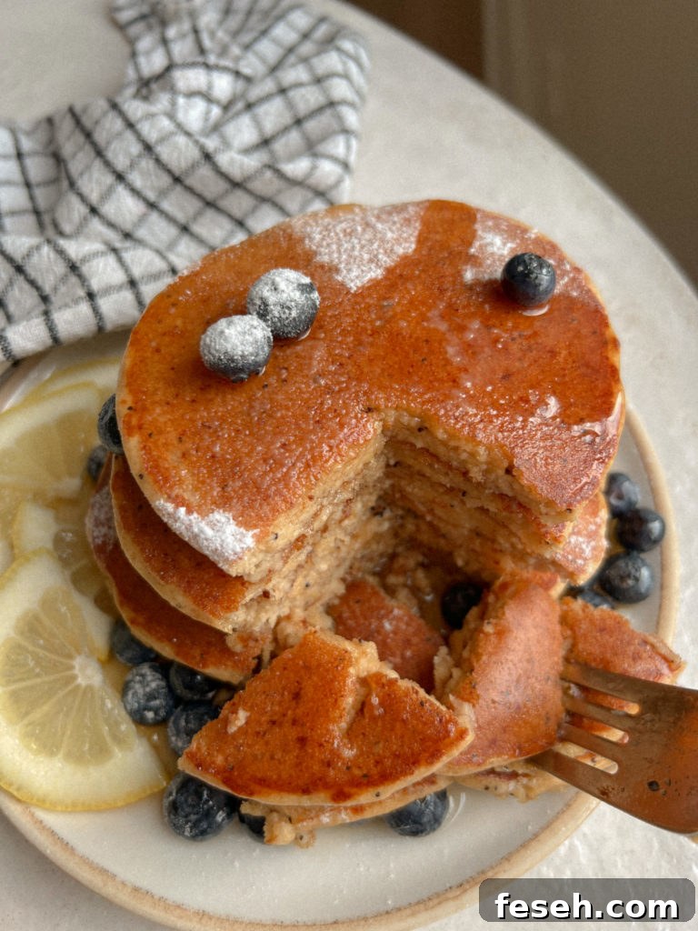 Fluffy Gluten-Free Lemon Ricotta Pancakes 4 Plate of lemon poppyseed pancakes with lemon slices