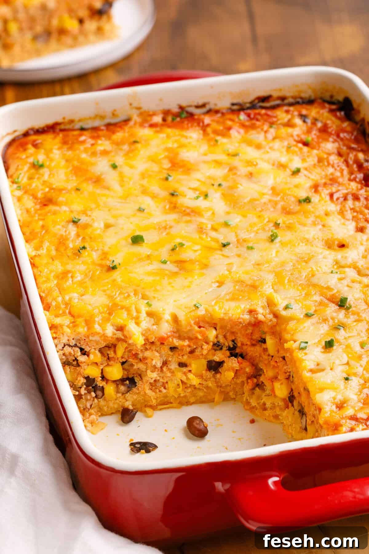 Mexican Breakfast Casserole in a baking dish with a serving taken out.