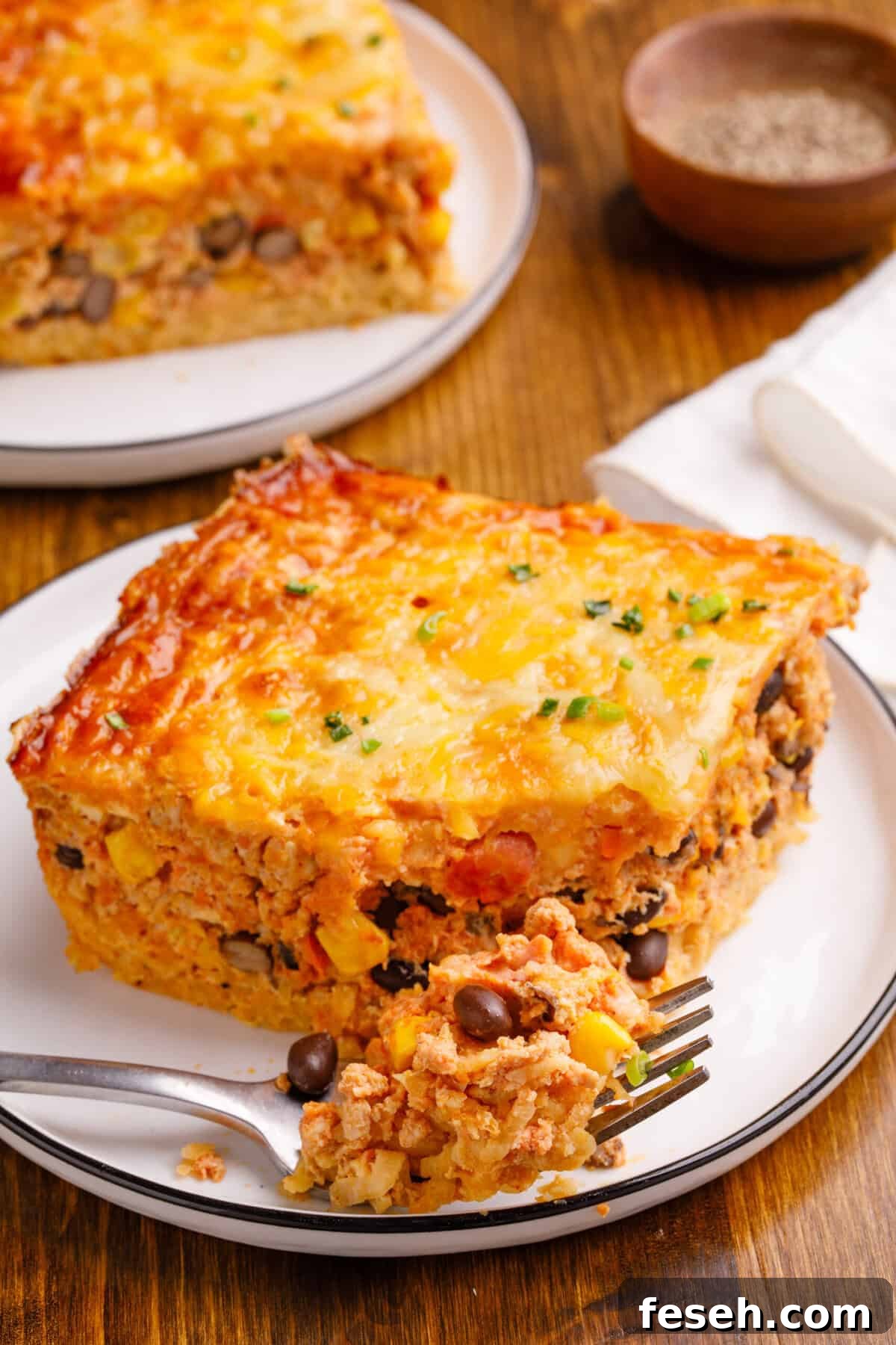Mexican Breakfast Casserole on a plate with a some casserole on a fork.