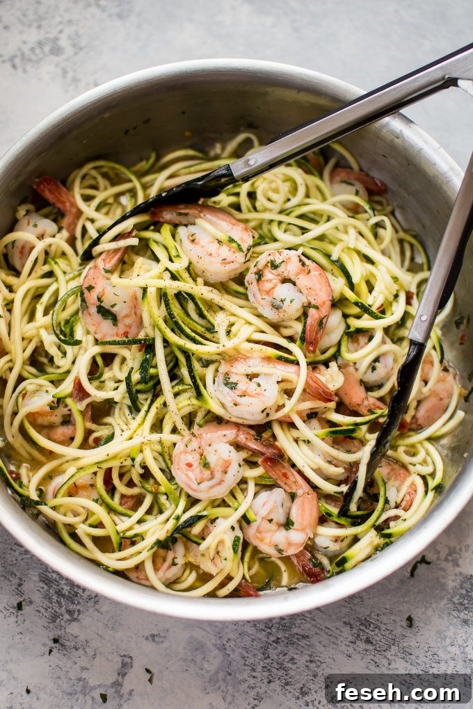 15-Minute Sweet Chili Shrimp with Zoodles Recipe 3 metal skillet with sweet chili shrimp zucchini noodles and tongs