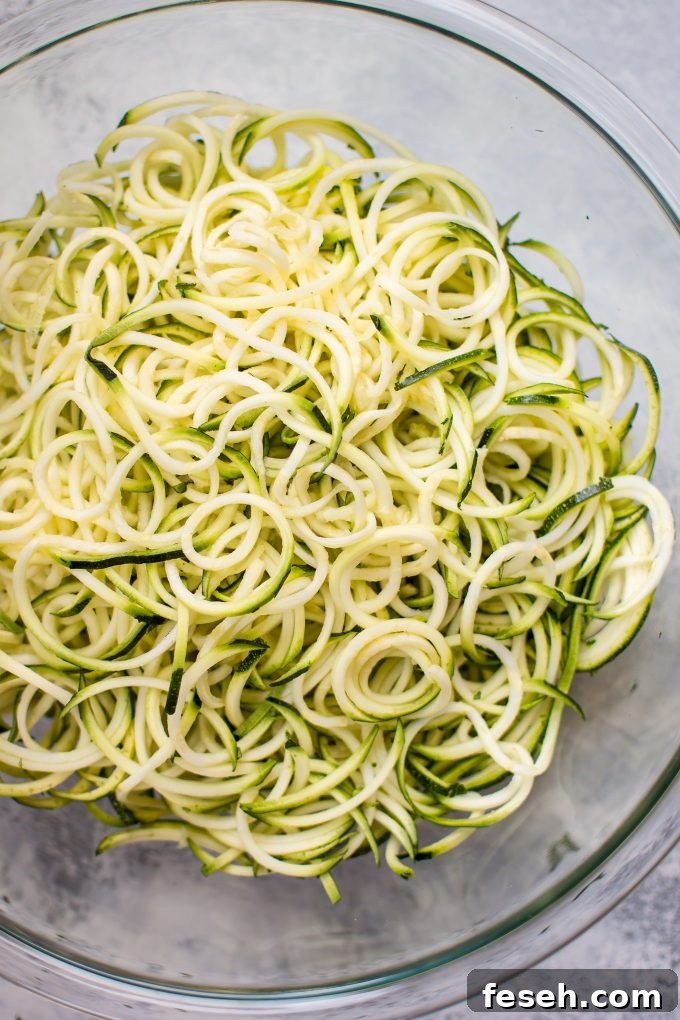 15-Minute Sweet Chili Shrimp with Zoodles Recipe 4 glass bowl of raw zucchini noodles