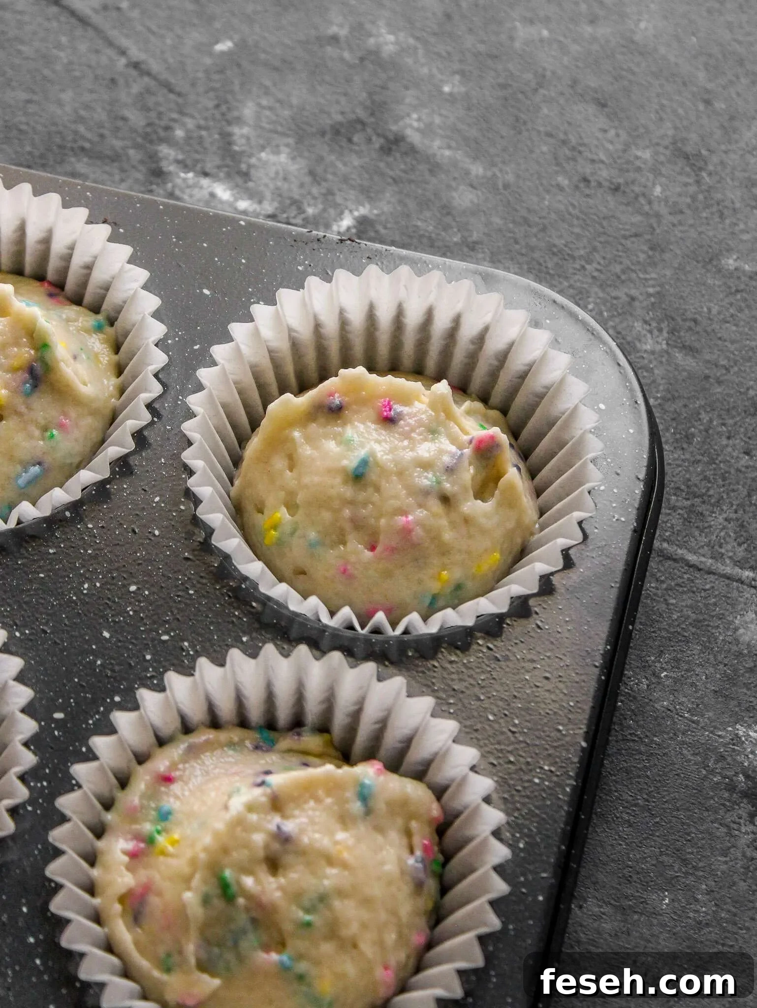 Classic Funfetti Cupcakes with Vanilla Frosting 9 funfetti cupcakes batter portioned into cupcake tin (2)
