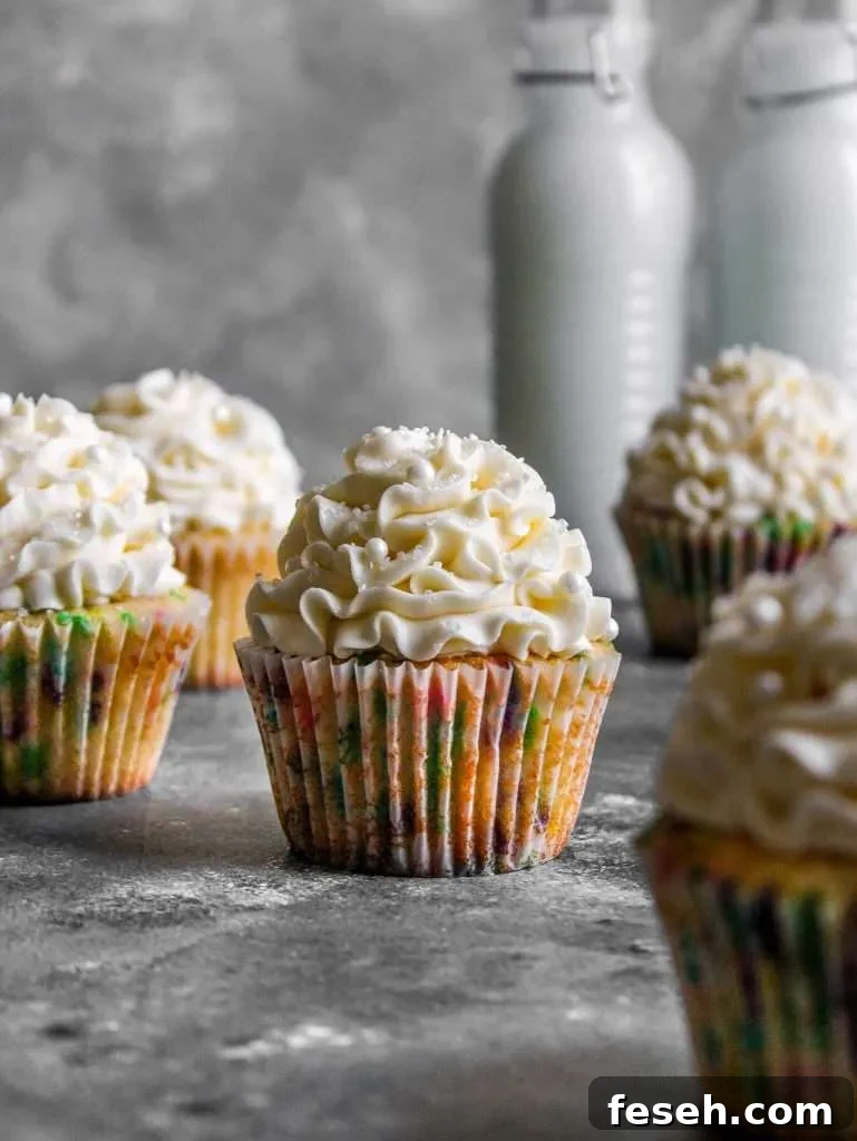 Classic Funfetti Cupcakes with Vanilla Frosting 8 frosted funfetti cupcakes on table
