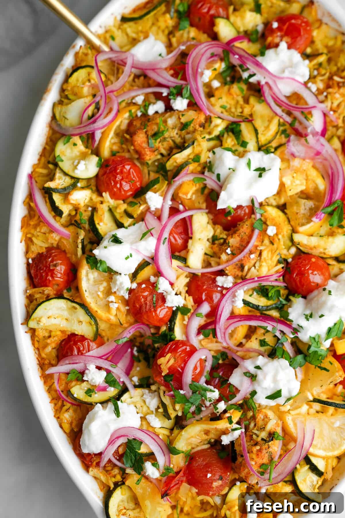Greek-Style Chicken Tzatziki Casserole 2 chicken tzatziki in a large casserole dish with a gold spoon