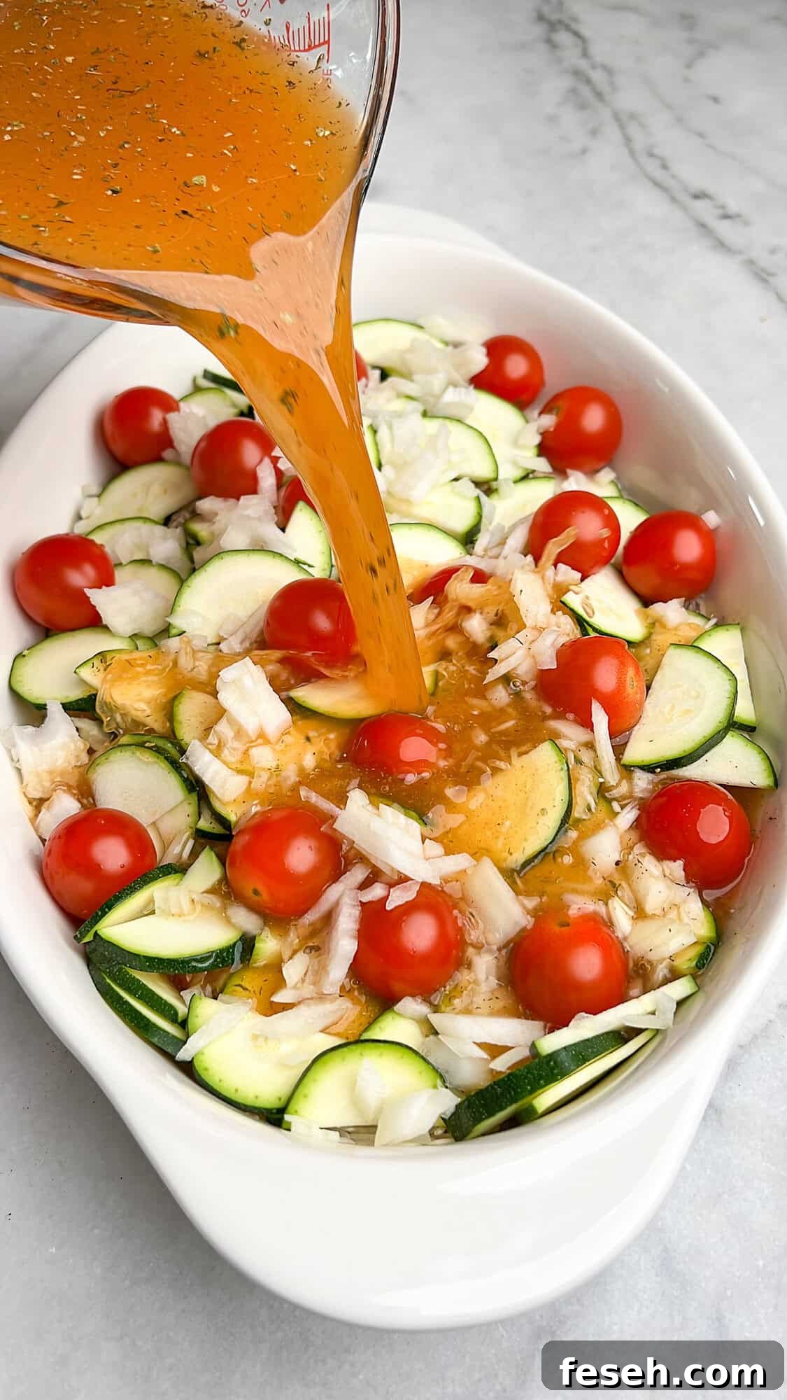 Greek-Style Chicken Tzatziki Casserole 10 pouring stock over ingredients