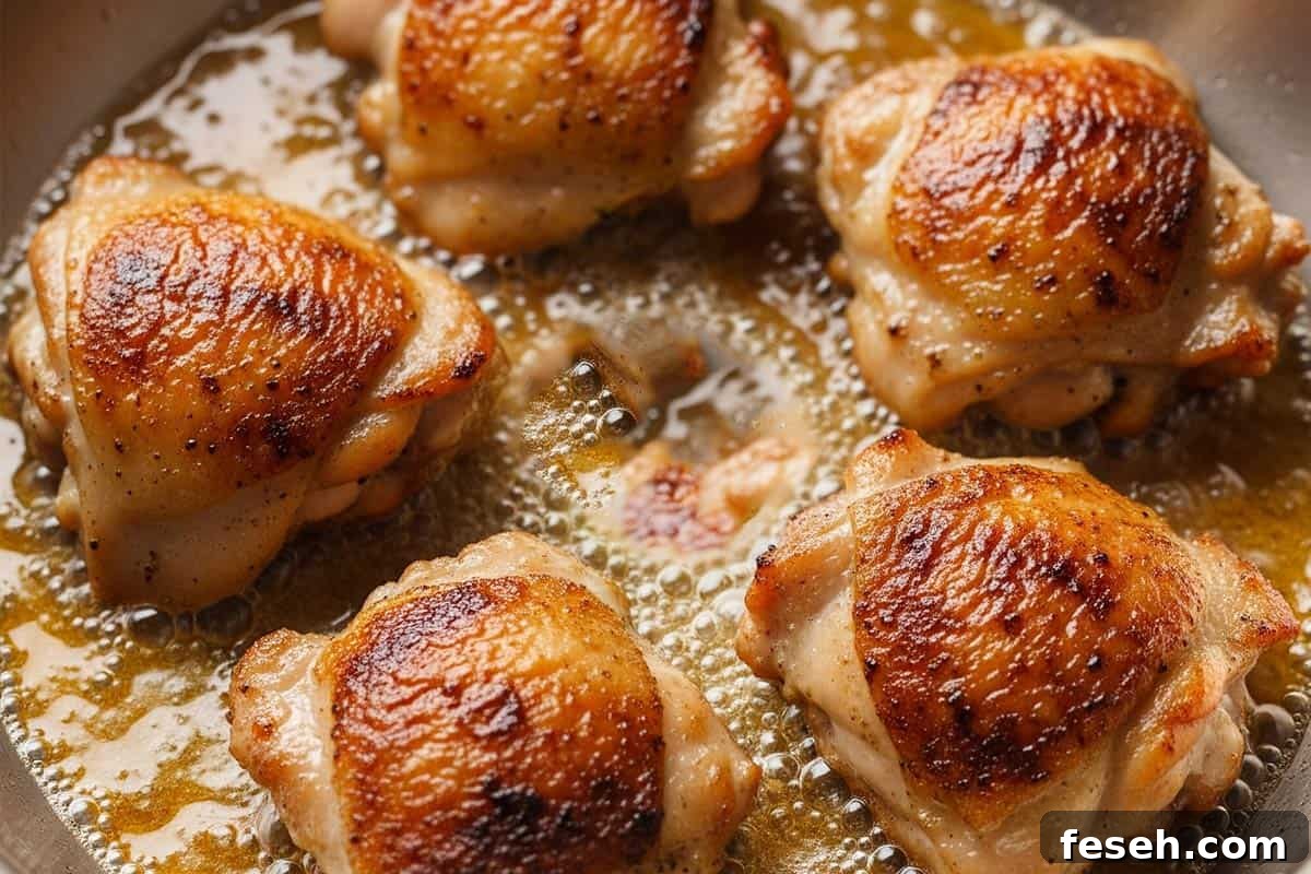 Creamy Lemon Garlic Chicken Recipe 5 Searing the chicken in a pan.