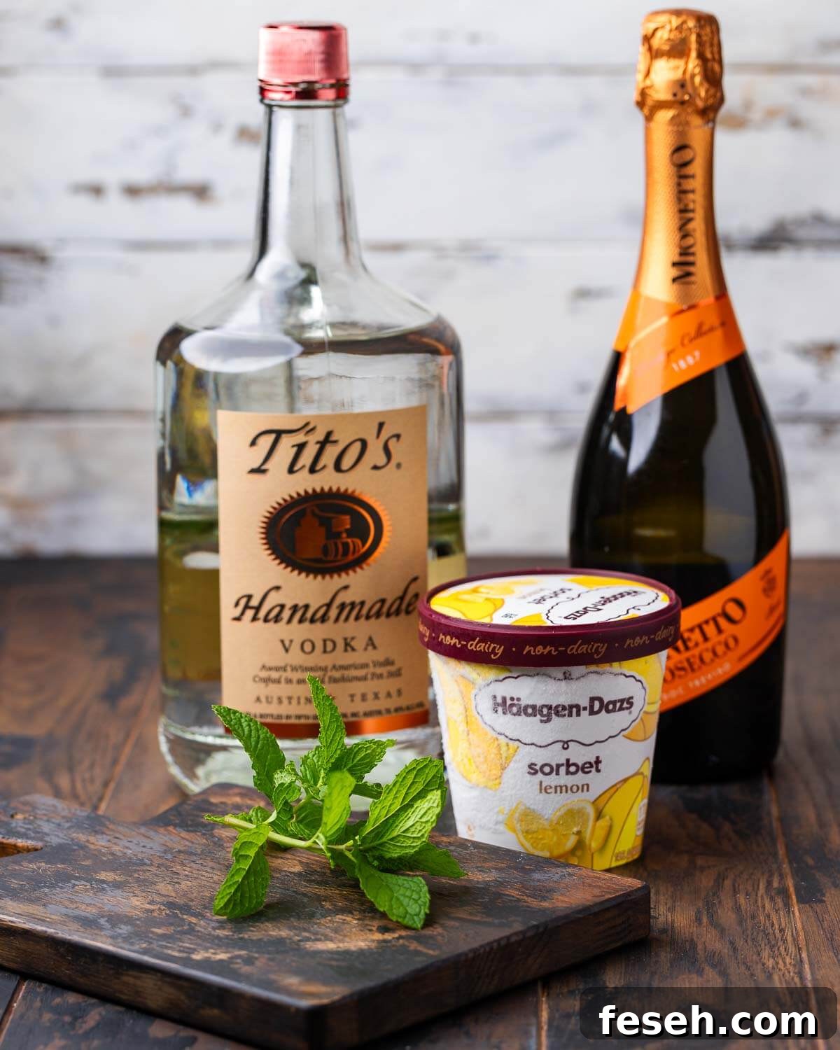 Sgroppino: Italian Lemon Sorbet and Prosecco Cocktail 3 Ingredients shown: vodka, prosecco, lemon sorbet, and mint.