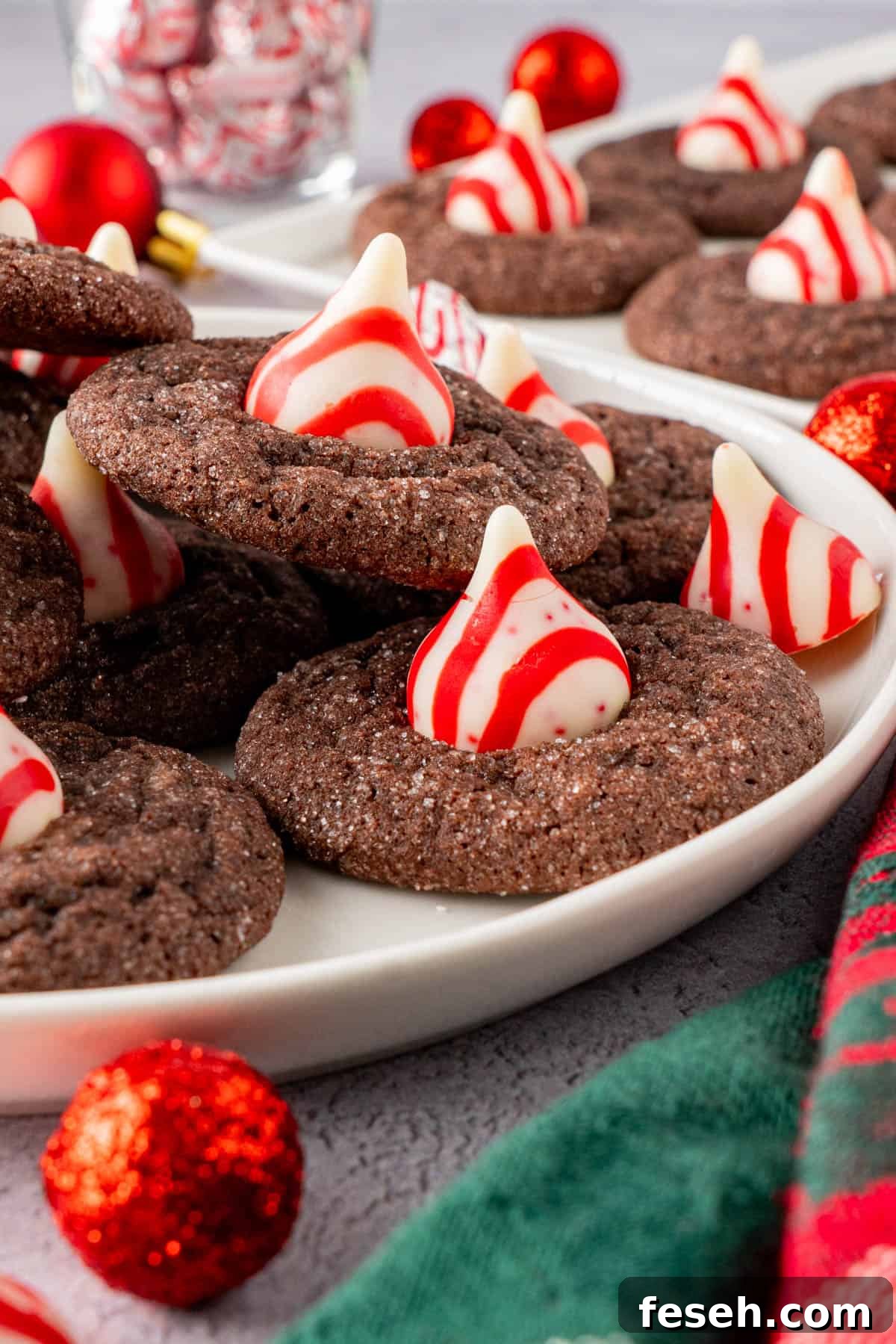Chocolate Kiss Cookies with Hershey Candy Cane Kisses 8 Chocolate Kiss Cookies With Hershey's Candy Cane Kisses on a plate ready to serve
