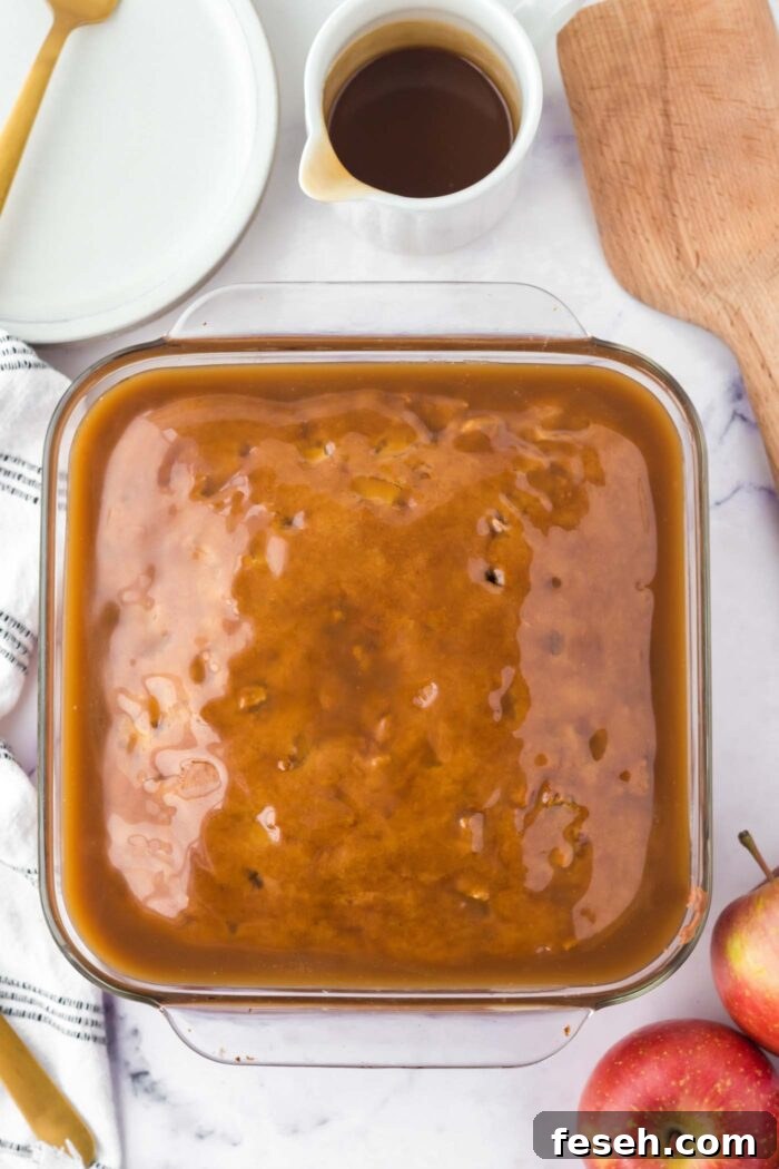Moist Vegan Apple Cake with Cinnamon Glaze 11 Overhead view of an apple cake covered in a layer of caramel glaze.