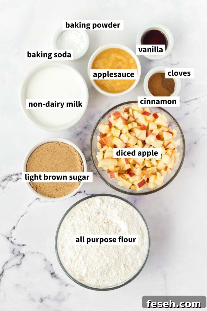 Moist Vegan Apple Cake with Cinnamon Glaze 3 A visual ingredient list of the ingredients for vegan apple cake gathered in bowls and labelled with text.