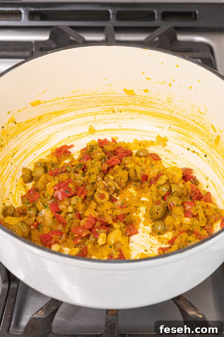 Puerto Rican Arroz con Mariscos Recipe - Authentic Seafood Rice 5 A pot with olives, onions, peppers and spices.