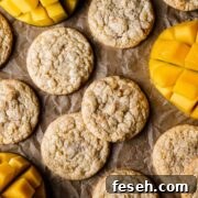 Tropical Mango Cookies with Coconut Glaze 19 Cookies with sliced mangos peeking into the image.