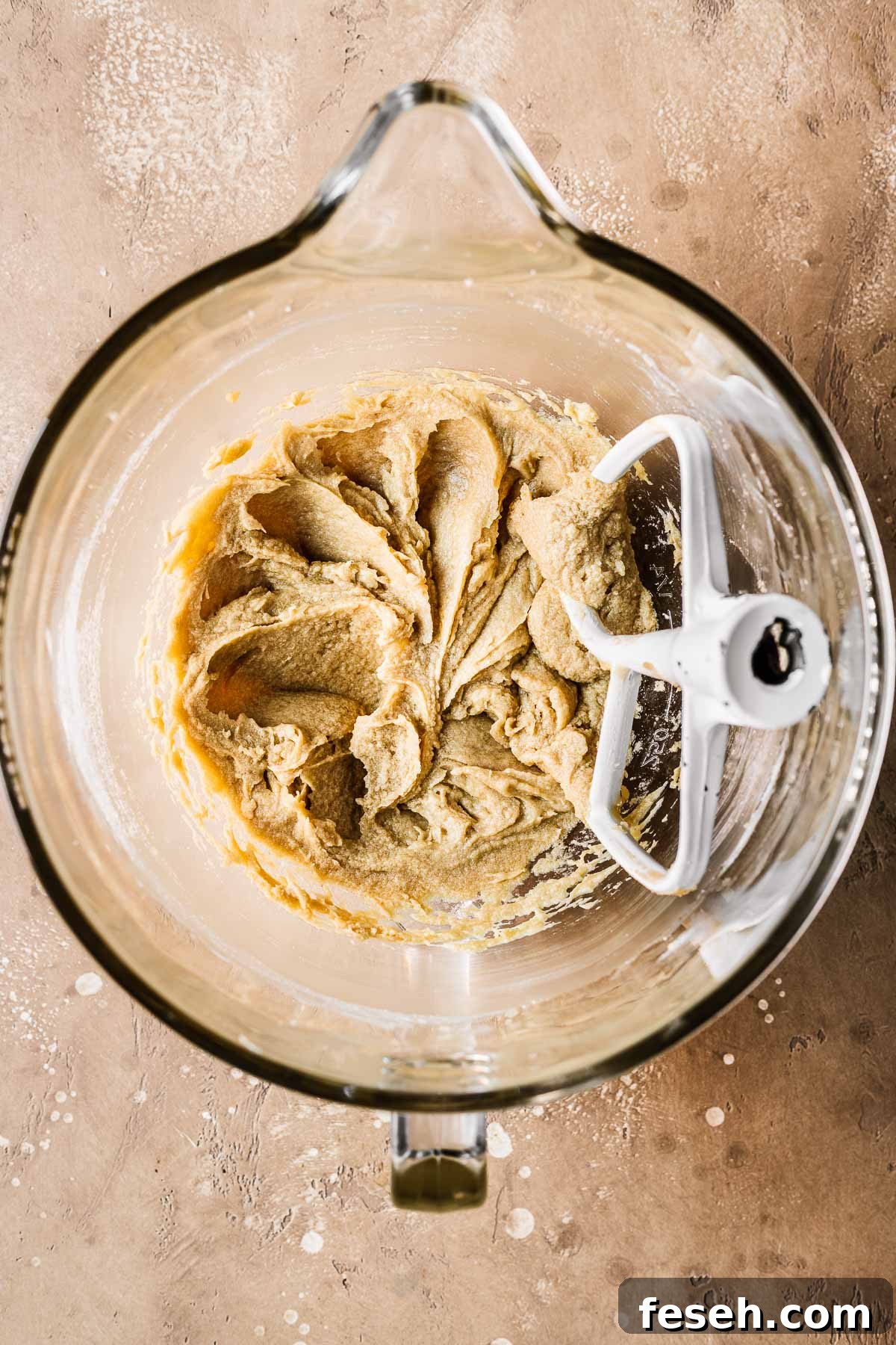 Tropical Mango Cookies with Coconut Glaze 8 Butter, sugar and eggs mixed together in a clear glass bowl.
