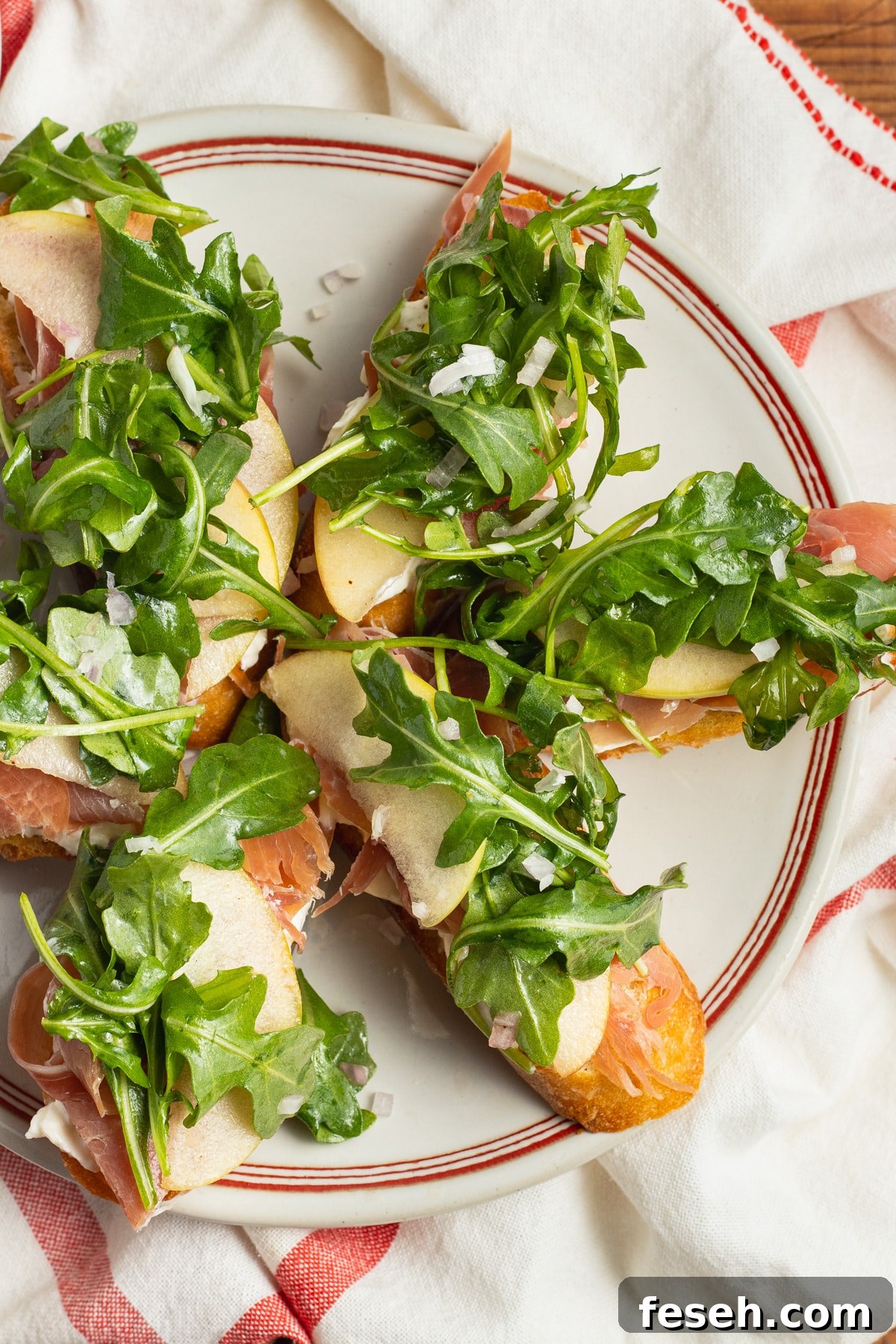 Crispy Crostini Topped with Burrata and Prosciutto 2 This is a picture of a plate with burrata crostini with prosciutto.