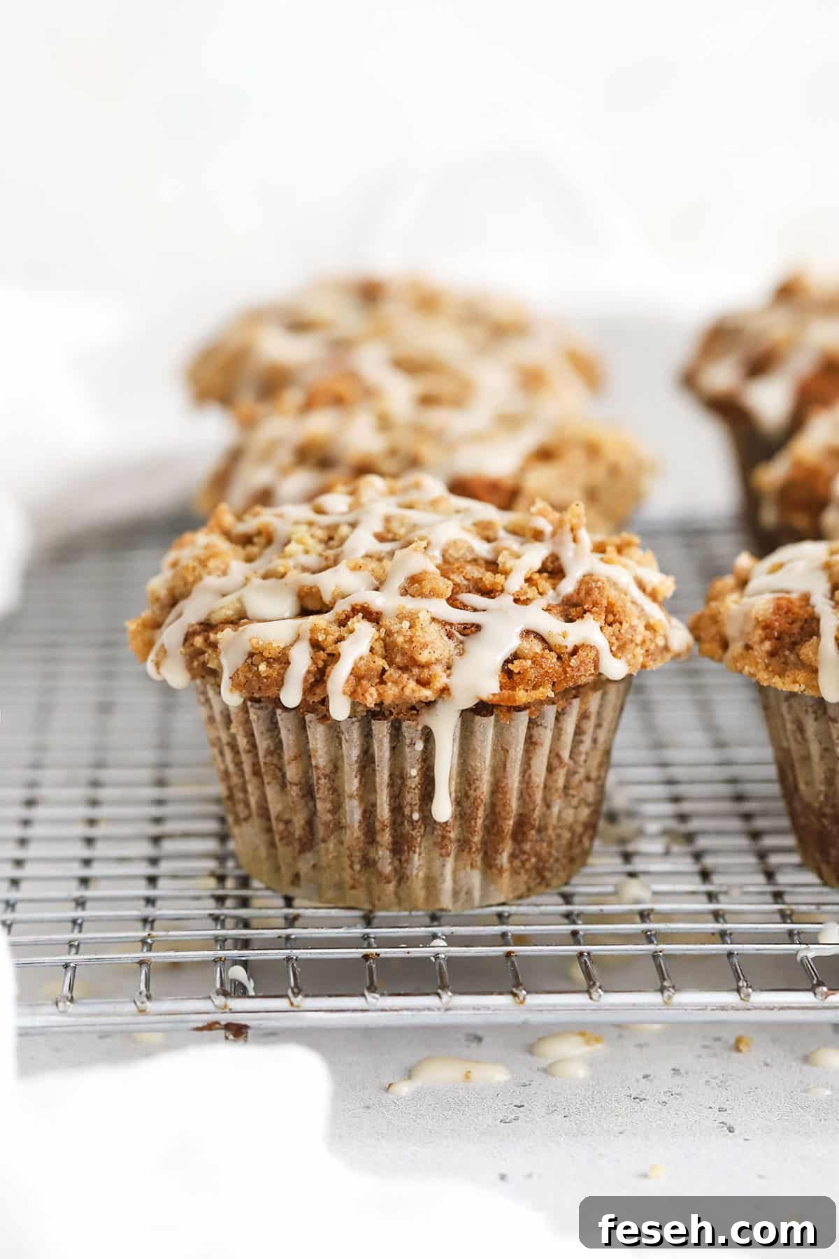 Gluten-Free Banana Crumb Muffins with Cinnamon Streusel 4 Gluten-Free Banana Crumb Muffin With cinnamon Streusel and maple glaze on a wire rack