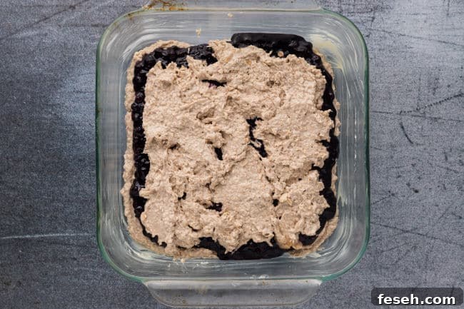 No Added Sugar Blueberry Pie Bars Recipe 12 Unbaked blueberry bars in a baking dish.